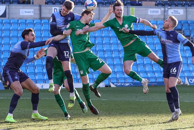 Preston North End's Paul Huntington and Alan Browne challenge in the air against Wycombe