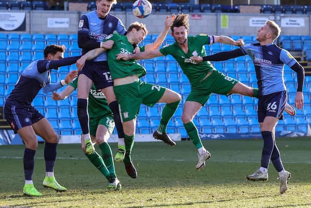 Paul Huntington challenges for the ball against Wycombe.