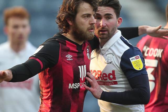 PNE striker Sean Maguire tussles with his former Deepdale team-mate Ben Pearson in the game against Bournemouth