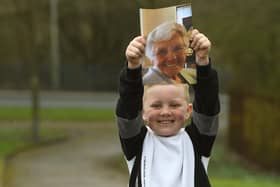 Ronnie Rea, 7, with a photo of his great-nana, Doreen who has inspired him to complete a Memory Walk. Photo: Neil Cross