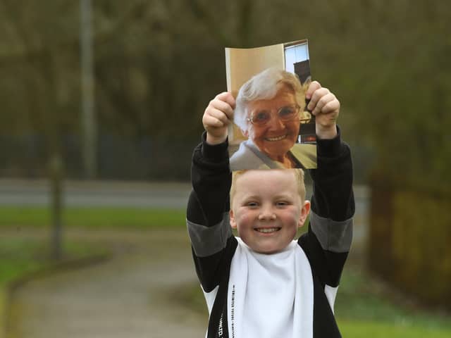 Ronnie Rea, 7, with a photo of his great-nana, Doreen who has inspired him to complete a Memory Walk. Photo: Neil Cross