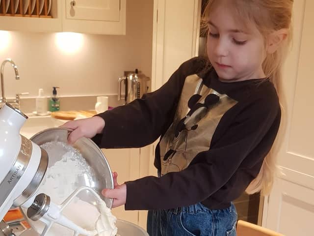 Amira Ratcliffe baking cakes which she sold to raise money for St John's Hospice.