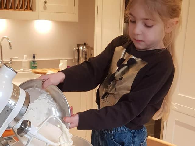 Amira Ratcliffe baking cakes which she sold to raise money for St John's Hospice.