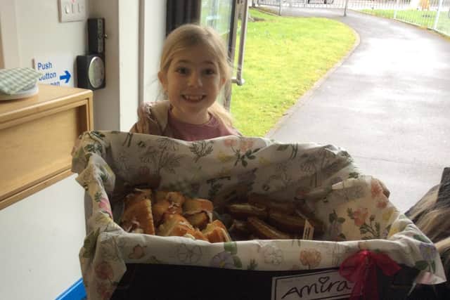 Amira Ratcliffe with some of the cakes she baked and sold for funds for St John's Hospice.