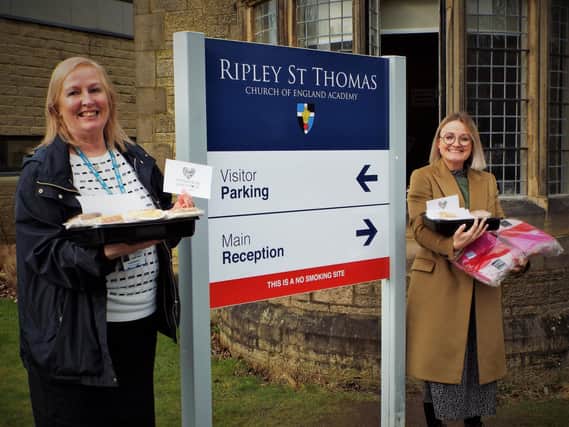 Bay Hospitals Charity manager Judith Read (left) is pictured receiving donations from Ripley St Thomas Church of England Academy's Sarah Taylor