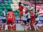 Preston North End goalkeeper Daniel Iversen gathers a cross in a crowded penalty box against Luton