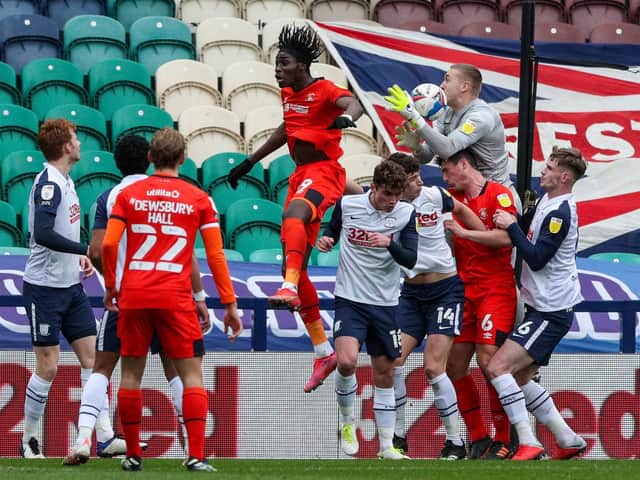Preston North End goalkeeper Daniel Iversen gathers a cross in a crowded penalty box against Luton