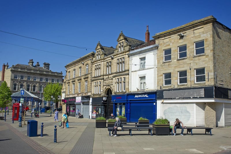 Locals go about their daily business in the Market Place, Dewsbury during the coronavirus lockdown.