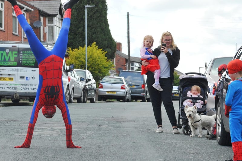 McKenzie Fisher dressed as superhero Spiderman on Vine Street, Whelley, Wigan. He has been entertaining children on their birthdays during the Covid-19 lockdown and raising funds for the NHS.
