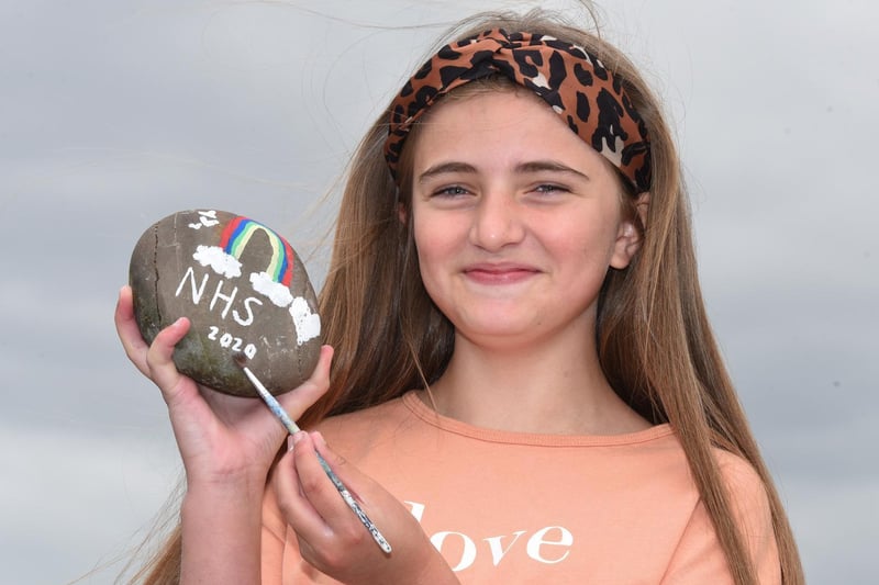 One of the many people who have been inspired to raise funds during the lockdown.  Pictured is Lyla Andrews, 12, from Standish, with some of her rainbow painted stones, she has raised over £400 for the NHS.