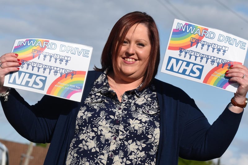 Another creative idea showing community spirit: Michelle Aidley with the signs she designed and sold to neighbours to raise money for charity. Residents of  Inward Drive, Shevington, have been fundraising for the NHS, with a variety of events, including weekly social-distanced bingo.