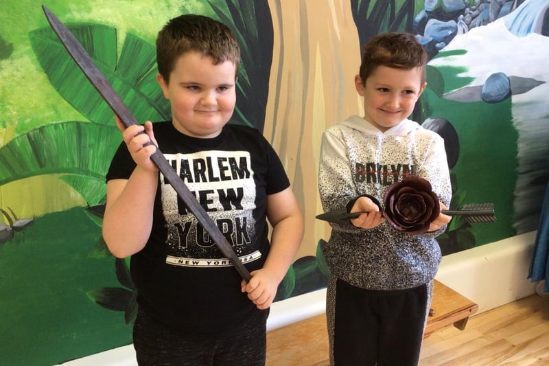 Junior and Riley holding some of the metal objects.