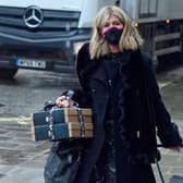 Kate Garraway carries gift boxes and pulls a suitcase as she arrives at Global Radio in London. Credit: PA Wire/PA Images. Picture by Ian West