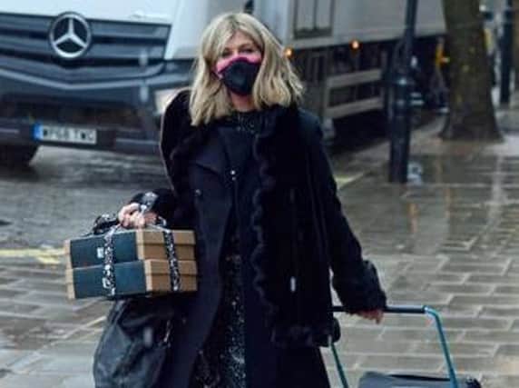 Kate Garraway carries gift boxes and pulls a suitcase as she arrives at Global Radio in London. Credit: PA Wire/PA Images. Picture by Ian West