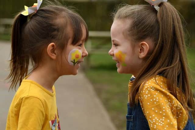 Children wore yellow and painted their faces to mark the sombre occasion