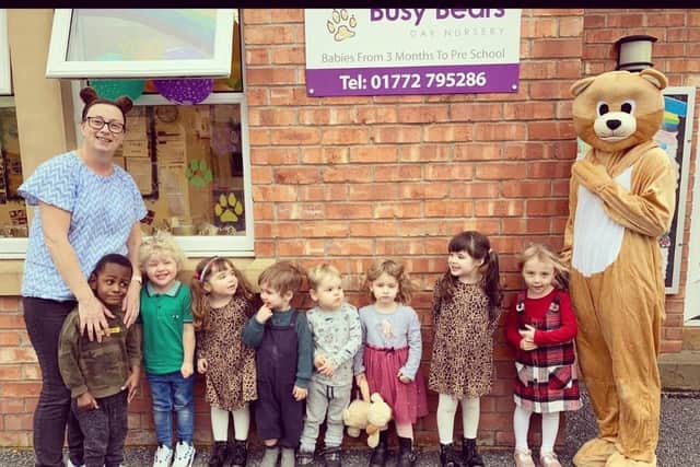 Busy Bears Nursery children with a real Busy Bear during 20th anniversary celebrations.