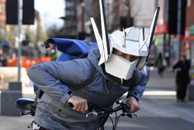 A cyclist with a unique take on safety with a home made helmet with built in face mask