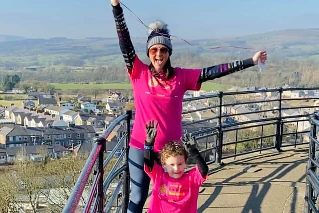 Heather celebrating with her four-year-old son, Hunter, having made it to the top of the Castle Keep