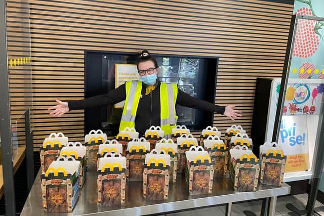 McDonald's employee Kathryn Ashurst with lots of Happy Meal boxes at lunch time