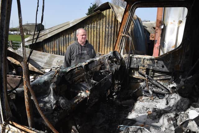 Mr Stoneley with the charred remains of his workshop