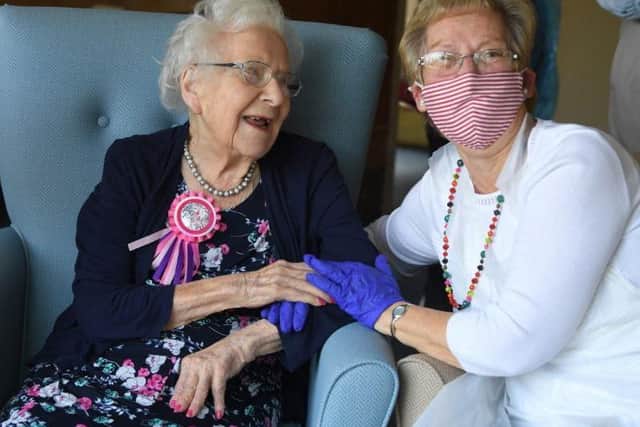 Pauline Archer holds her mums hand as she turns 101