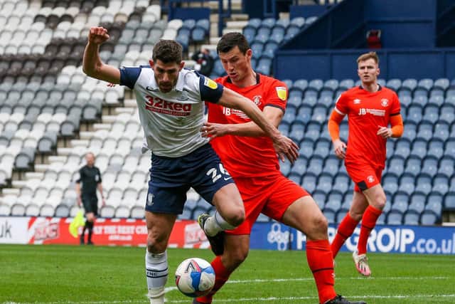 Preston North End striker Ched Evans shields the ball from Luton defender Matty Pearson