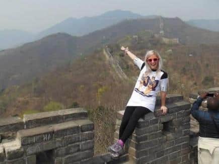 Amy on the Great Wall of China which inspired her charity fundraiser.