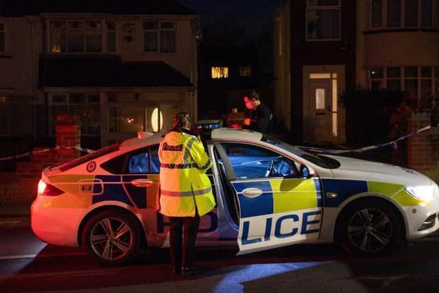 Police at the scene in Rowley Regis, West Midlands where a woman in her 80s died after being attacked by two escaped dogs