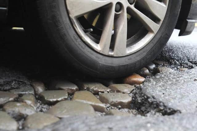Cobblestones have reappeared on some Lancashire streets where the more modern surface above has started to disintegrate