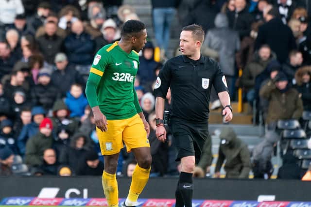 Preston right-back Darnell Fisher has a chat with referee David Webb in the game against Fulham at Craven Cottage