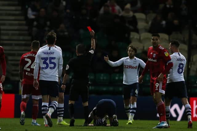 Joe Rafferty (on the floor) gets a red card in PNE's win over Fulham at Deepdale in December
