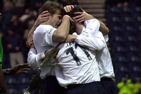 Brian McBride (left), David Healy and Jonathan Macken celebrate