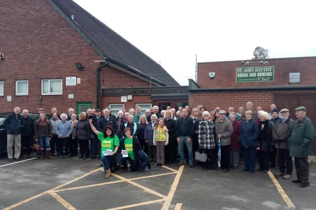 Locals gather outside St. Martin's in November 2018, after plans to demolish the chapel and parish hall were made public
