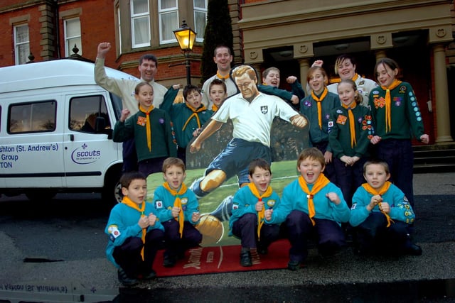 Members of the 2nd Ashton St Andrew’s Scout Group help move the Sir Tom Finney painting from the Marriott Hotel at Broughton to the National Football Museum in Deepdale