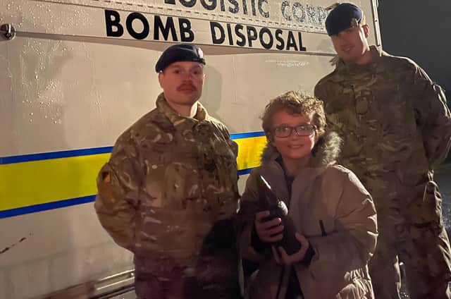 William Hartley with members of the Royal Logistics Corps bomb disposal team and the World War One bomb.