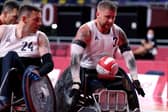 Britain's Stuart Robinson (R), a veteran who was wounded in Afghanistan, rolls to score during the pool phase group B wheelchair rugby match between Britain and Canada during the Tokyo 2020 Paralympic Games at the Yoyogi National Stadium in Tokyo on August 25, 2021. (Photo by Behrouz MEHRI / AFP) (Photo by BEHROUZ MEHRI/AFP via Getty Images)