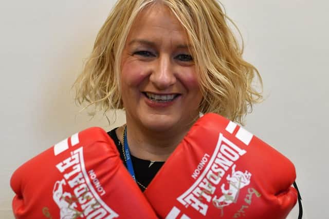 Christine Metcalfe of Bay Hospitals Charity with the gloves signed by world heavyweight champ Tyson Fury