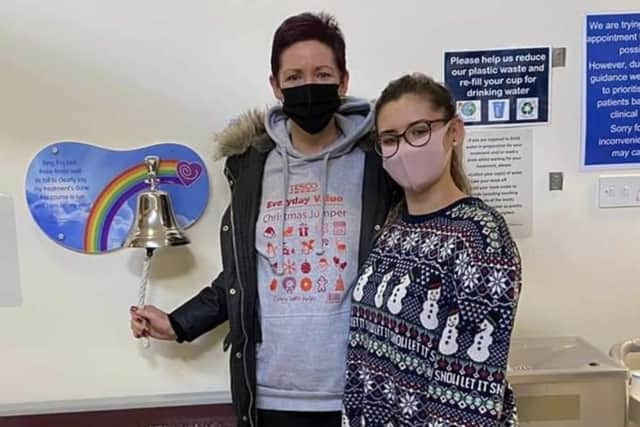 Andrea ringing the cancer free bell at Rosemere Cancer Centre in Preston with her daughter Elizabeth on Christmas eve 2020.