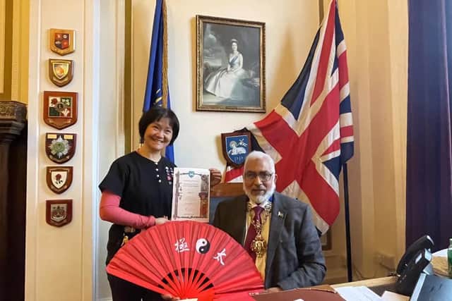UCLan director Feixia Yu receiving her Covid hero award from Councillor Javed Iqbal, Mayor of Preston.