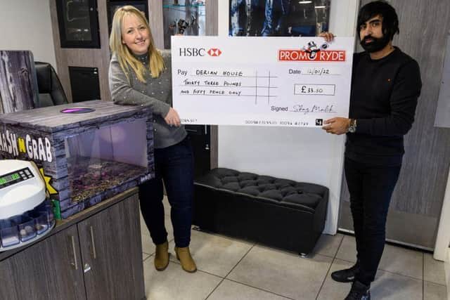 LEP reporter Catherine Musgrove and Shaz Malik of Promo Ryde with the cheque for Derian House