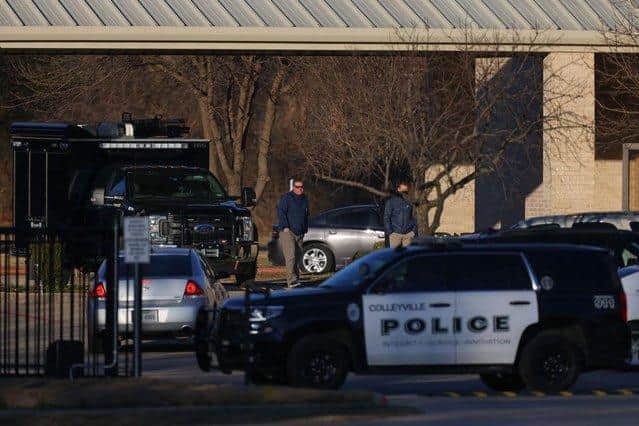 A Police car sits in front of the Congregation Beth Israel Synagogue in Colleyville, Texas, some 25 miles (40 kilometers) west of Dallas, on January 16, 2022