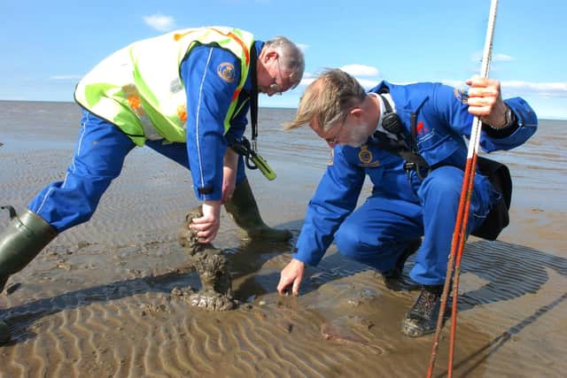 Morecambe coastguard station officer Alex Bottomley (left) and deputy Eric Greenough unearth one of the six unexpolded wartime shells found on the beach off Heysham Head in 2007.