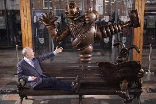 Nick Park relaxes on the Wallace and Gromit bench outside Market Hall in Preston