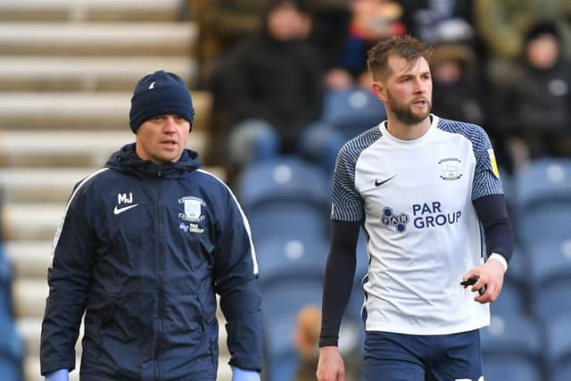 Preston North End's Tom Barkhuizen comes off with physio Matt Jackson after being injured against Fulham in November