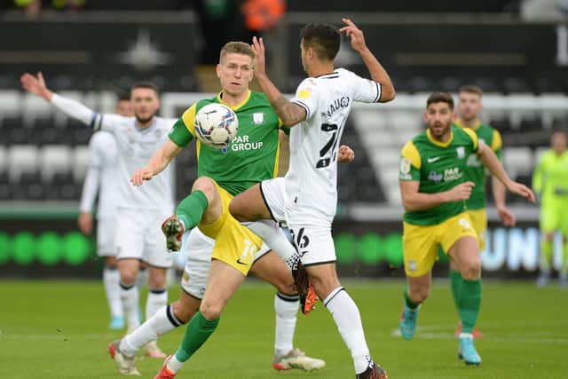 PNE striker Emil Riis sees his way blocked by Swansea defender Kyle Naughton