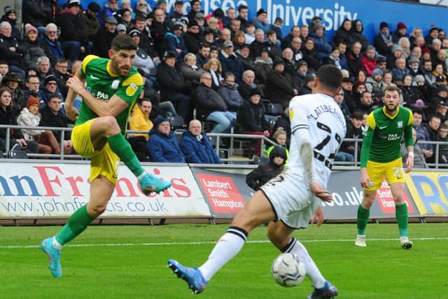 PNE striker Ched Evans drives in a shot which Swansea's Joel Latibeaudiere attempts to block