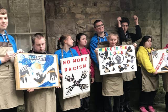 Pupil of Loyne Special School with anti-slavery placards they created