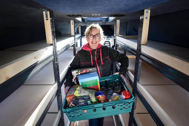 Mandy Hudson tests out the new shelving in the mobile larder