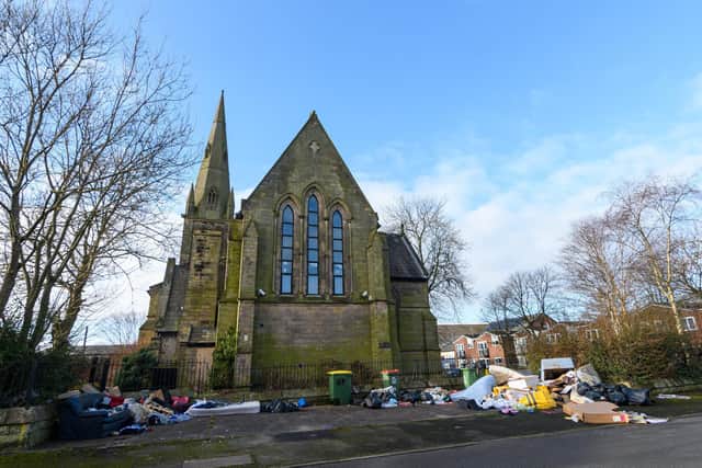The disused  Grade II listed St Luke's church and the rubbish dumped outside its grounds