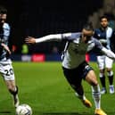 Preston North End striker Cameron Archer takes on Huddersfield's Ollie Turton at Deepdale